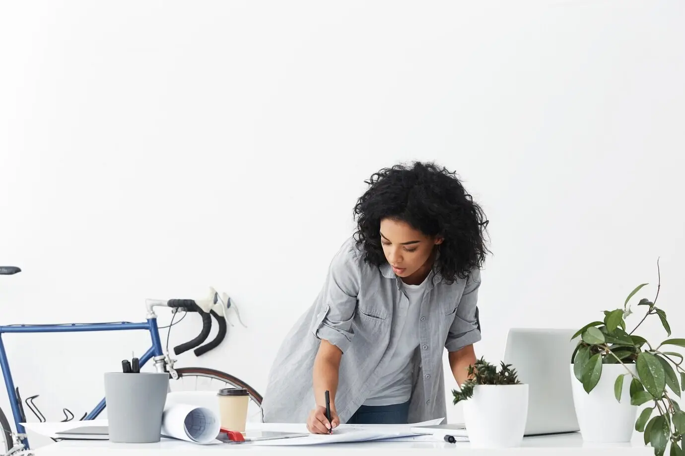 A good-looking, focused young African American woman engineer creating a sketch.